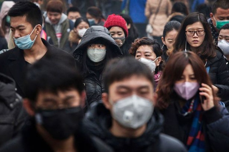 Chinese commuters many wearing masks walk to work during heavy pollution.jpg?ixlib=rails 2.1