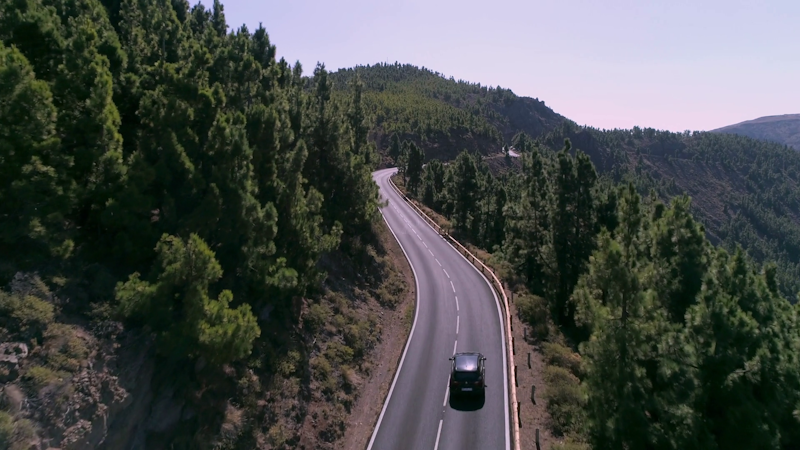 Videoblocks aerial silver car driving on a lonely mountain road through the pine tree forest hkrszsrug thumbnail full02.png?ixlib=rails 2.1