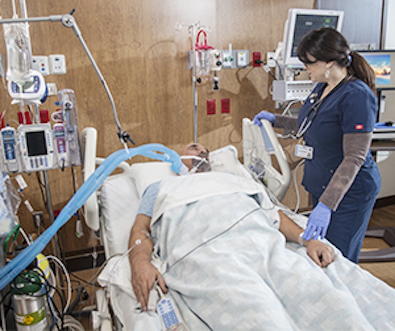 Patient lying in intensive care unit bed with medical machines surrounding.jpeg?ixlib=rails 2.1