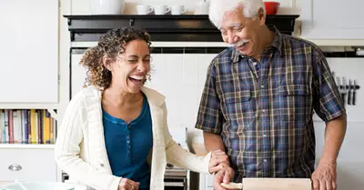 14338 senior dad and adult daughter baking together.jpg?ixlib=rails 2.1